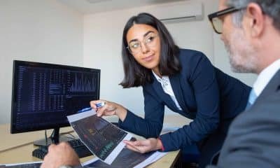 Boss and financial expert discussing trading strategy, studying financial data. Closeup shot. Broker job concept